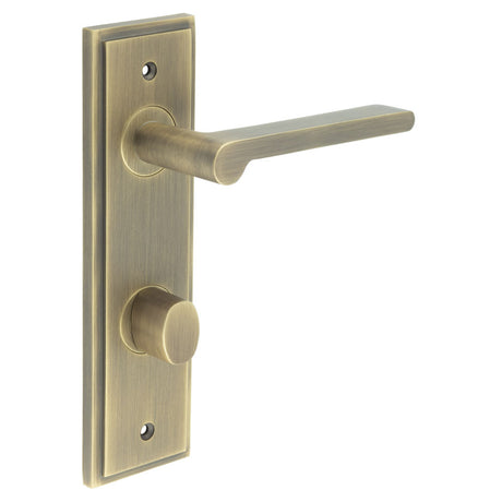 This is an image showing the Frelan - Fitzrovia Door Handle Din Bathroom Backplate Antique Brass & Turn & Release available to order from T.H. Wiggans Ironmongery in Kendal