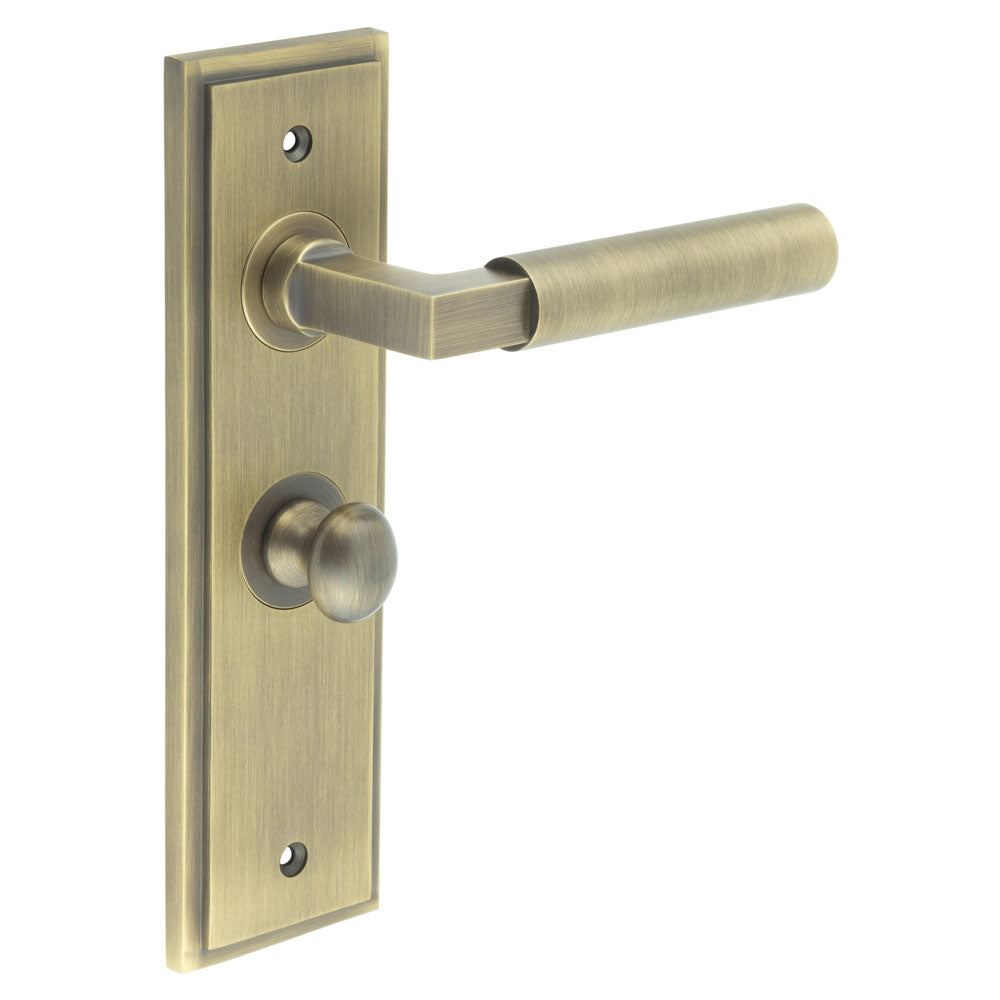 This is an image showing the Frelan - Westminster Door Handle Bathroom Backplate Antique Brass & Turn & Release available to order from T.H. Wiggans Ironmongery in Kendal