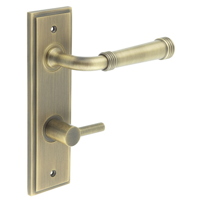 This is an image showing the Frelan - Highgate Door Handle Din Bathroom Backplate Antique Brass & Turn & Release available to order from T.H. Wiggans Ironmongery in Kendal