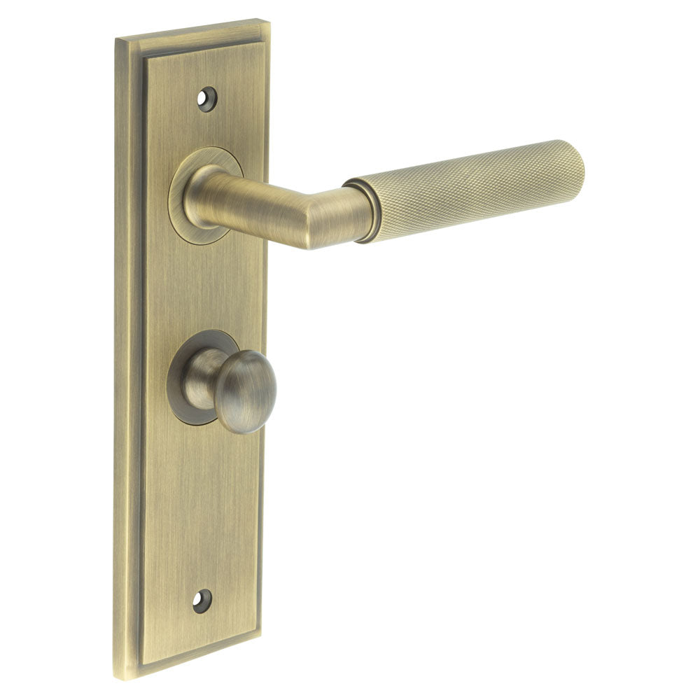 This is an image showing the Frelan - Piccadilly Door Handle Bathroom Backplate Antique Brass & Turn & Release available to order from T.H. Wiggans Ironmongery in Kendal