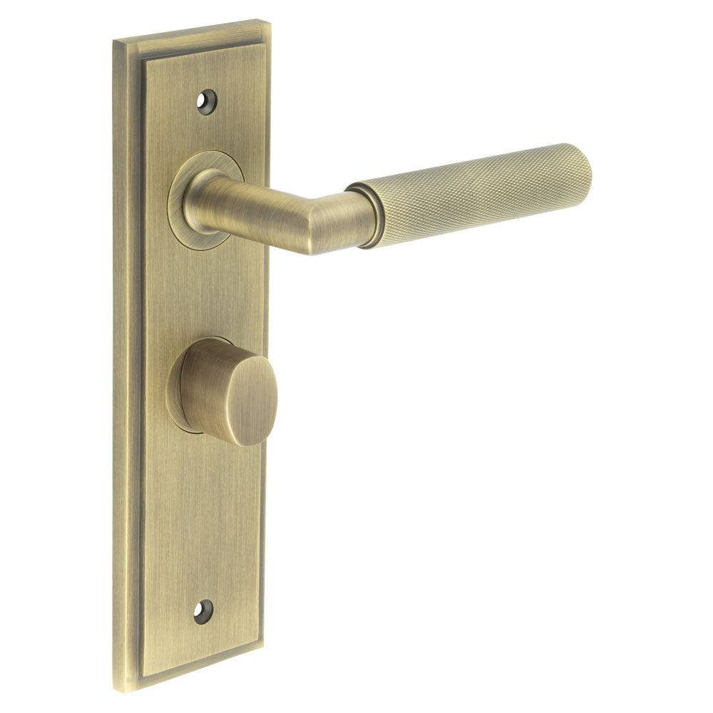 This is an image showing the Frelan - Piccadilly Door Handle Bathroom Backplate Antique Brass & Turn & Release available to order from T.H. Wiggans Ironmongery in Kendal