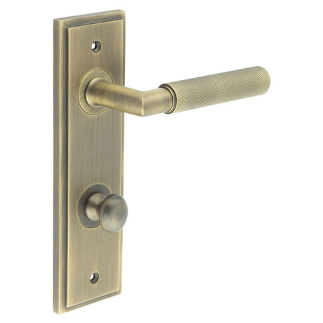 This is an image showing the Frelan - Piccadilly Door Handle Din Bathroom Backplate Antique Brass & Turn & Release available to order from T.H. Wiggans Ironmongery in Kendal