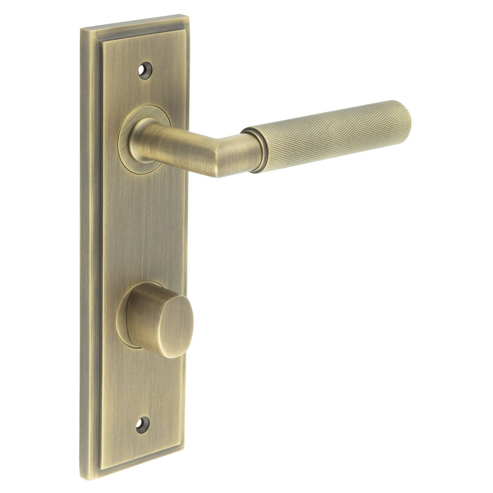 This is an image showing the Frelan - Piccadilly Door Handle Din Bathroom Backplate Antique Brass & Turn & Release available to order from T.H. Wiggans Ironmongery in Kendal