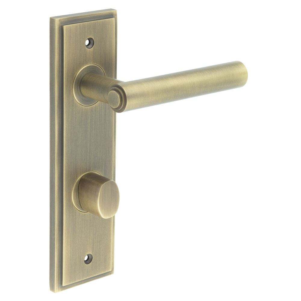 This is an image showing the Frelan - Richmond Door Handle Din Bathroom Backplate Antique Brass & Turn & Release available to order from T.H. Wiggans Ironmongery in Kendal