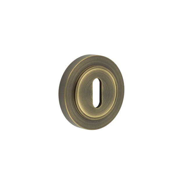 This is an image showing the Frelan - Burlington Standard Keyway Escutcheons Plain Rose Antique Brass available to order from T.H. Wiggans Ironmongery in Kendal