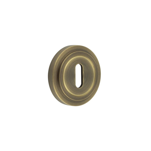This is an image showing the Frelan - Burlington Standard Keyway Escutcheons Stepped Rose Antique Brass available to order from T.H. Wiggans Ironmongery in Kendal