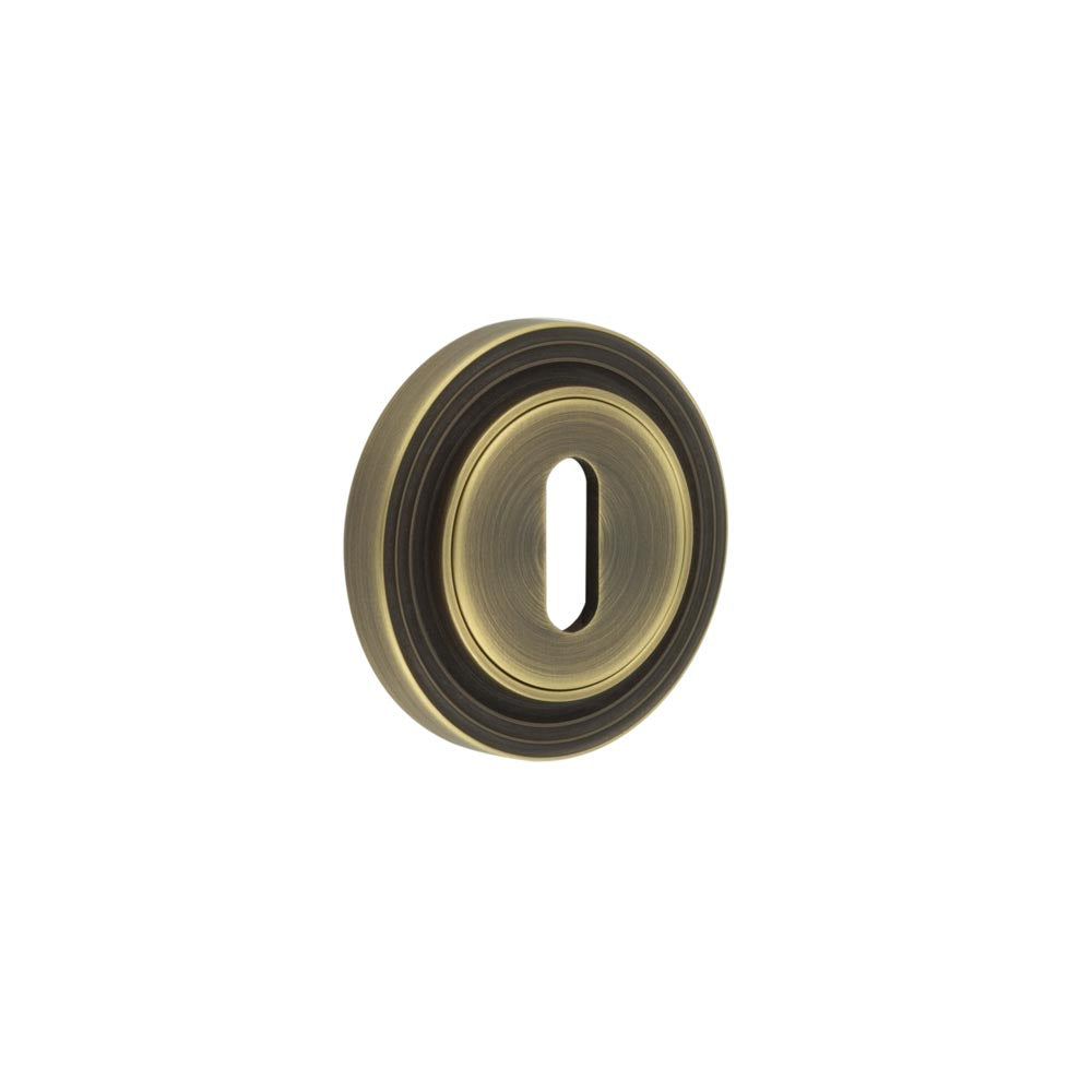 This is an image showing the Frelan - Burlington Standard Keyway Escutcheons Reeded Rose Antique Brass available to order from T.H. Wiggans Ironmongery in Kendal