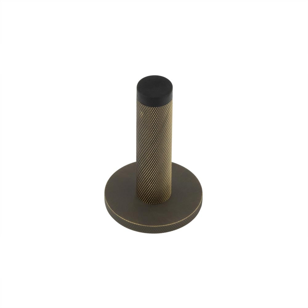 This is an image showing the Frelan - Burlington Knurled Wall Mounted Door Stop Knurled Rose Antique Brass available to order from T.H. Wiggans Ironmongery in Kendal