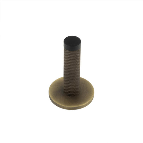 This is an image showing the Frelan - Burlington Knurled Wall Mounted Door Stop Plain Rose Antique Brass available to order from T.H. Wiggans Ironmongery in Kendal