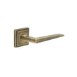 This is an image showing the Frelan - Mayfair Door Handle on Square Stepped Rose Antique Brass available to order from T.H. Wiggans Ironmongery in Kendal