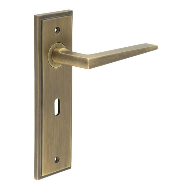 This is an image showing the Frelan - Mayfair Door Handle Lock Backplate Antique Brass available to order from T.H. Wiggans Ironmongery in Kendal