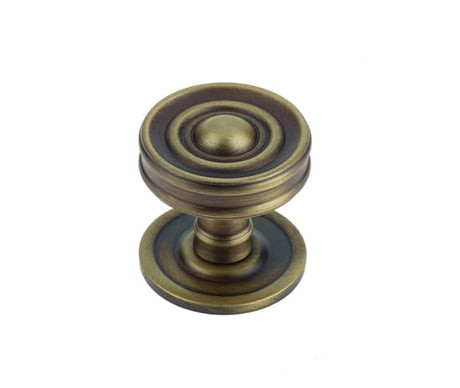 This is an image showing the Burlington - Bloomury cupboard knob - Antique Brass available to order from T.H. Wiggans Ironmongery in Kendal