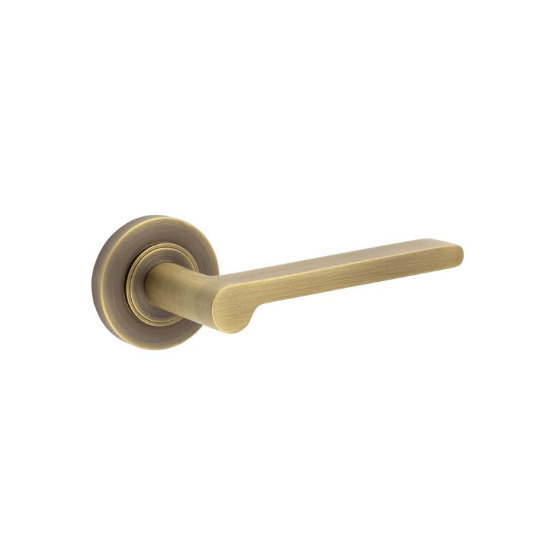 This is an image showing the Frelan - Fitzrovia Door Handles Plain Rose Antique Brass available to order from T.H. Wiggans Ironmongery in Kendal