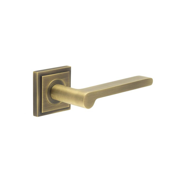 This is an image showing the Frelan - Fitzrovia Door Handles Square Stepped Rose Antique Brass available to order from T.H. Wiggans Ironmongery in Kendal