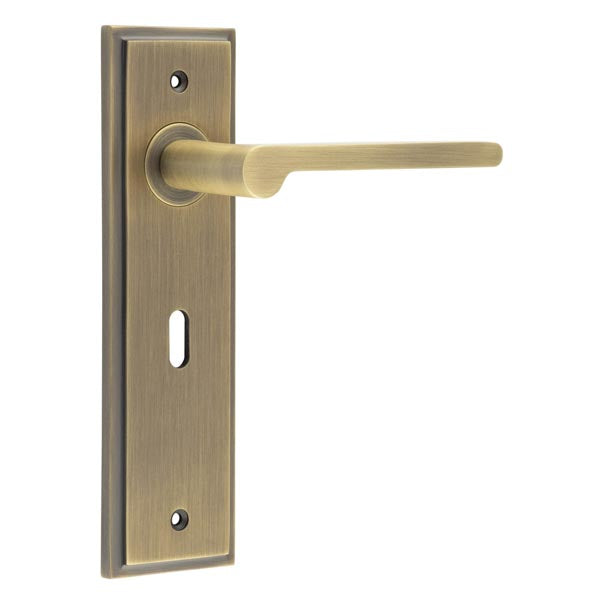 This is an image showing the Frelan - Fitzrovia Door Handle Lock Backplate Antique Brass available to order from T.H. Wiggans Ironmongery in Kendal