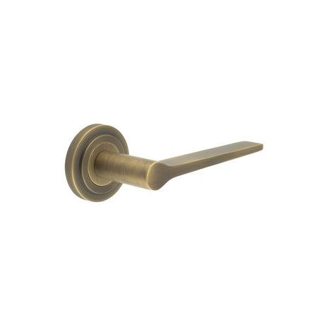 This is an image showing the Frelan - Knightsbridge Door Handle on Stepped Rose Antique Brass available to order from T.H. Wiggans Ironmongery in Kendal