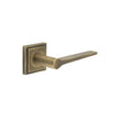 This is an image showing the Frelan - Knightsbridge Door Handle on Square Stepped Rose Antique Brass available to order from T.H. Wiggans Ironmongery in Kendal