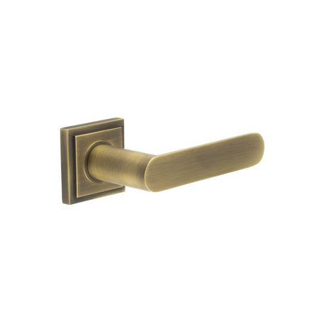 This is an image showing the Frelan - Kensington Door Handles Square Stepped Rose Antique Brass available to order from T.H. Wiggans Ironmongery in Kendal