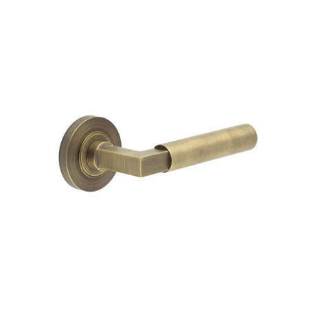 This is an image showing the Frelan - Westminster Door Handle on Plain Rose Antique Brass available to order from T.H. Wiggans Ironmongery in Kendal