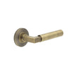 This is an image showing the Frelan - Westminster Door Handle on Chamfered Rose Antique Brass available to order from T.H. Wiggans Ironmongery in Kendal