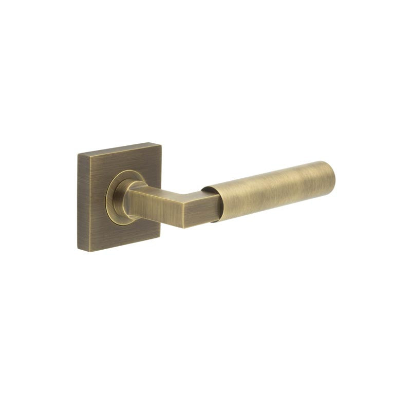 This is an image showing the Frelan - Westminster Door Handle on Square Plain Rose Antique Brass available to order from T.H. Wiggans Ironmongery in Kendal