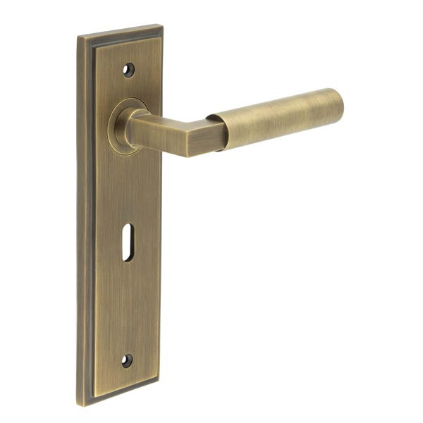 This is an image showing the Frelan - Westminster Door Handle Lock Backplate Antique Brass available to order from T.H. Wiggans Ironmongery in Kendal