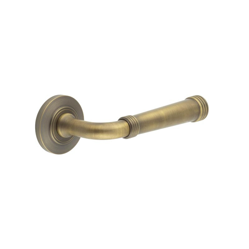 This is an image showing the Frelan - Highgate Door Handles Chamfered Rose Antique Brass available to order from T.H. Wiggans Ironmongery in Kendal