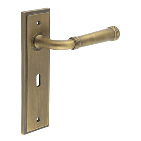 This is an image showing the Frelan - Highgate Door Handle Lock Backplate Antique Brass available to order from T.H. Wiggans Ironmongery in Kendal