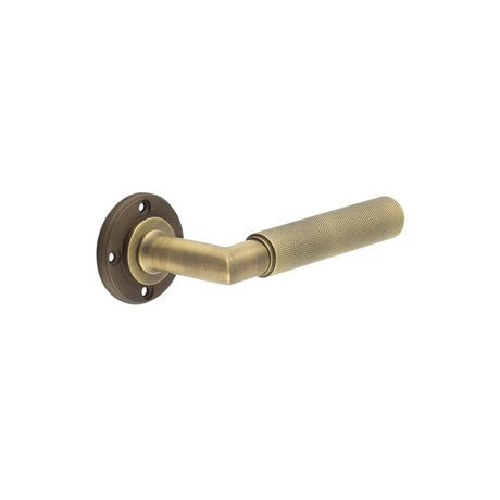 This is an image showing the Burlington - Piccadilly lever on rose - Antique Brass available to order from T.H. Wiggans Ironmongery in Kendal