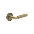 This is an image showing the Frelan - Piccadilly Door Handle on Plain Rose Antique Brass available to order from T.H. Wiggans Ironmongery in Kendal