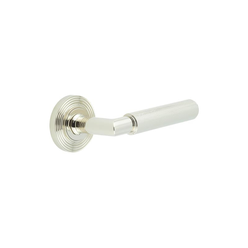 This is an image showing the Frelan - Piccadilly Door Handle on Reeded Rose Polished Nickel available to order from T.H. Wiggans Ironmongery in Kendal