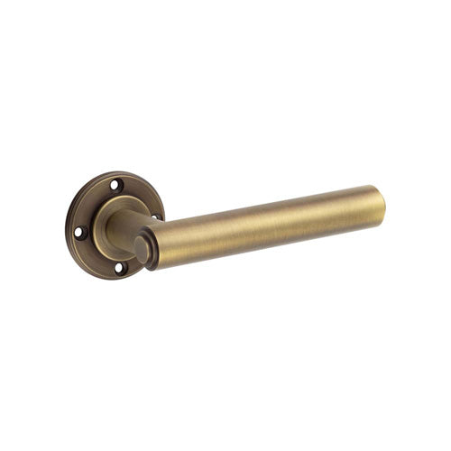 This is an image showing the Burlington - Richmond Antique Brass Lever on Rose Door Handle - Roses Sold Separ available to order from T.H. Wiggans Ironmongery in Kendal
