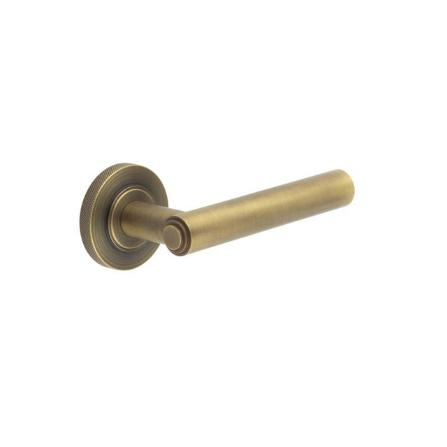 This is an image showing the Frelan - Richmond Door Handles Knurled Rose Antique Brass available to order from T.H. Wiggans Ironmongery in Kendal