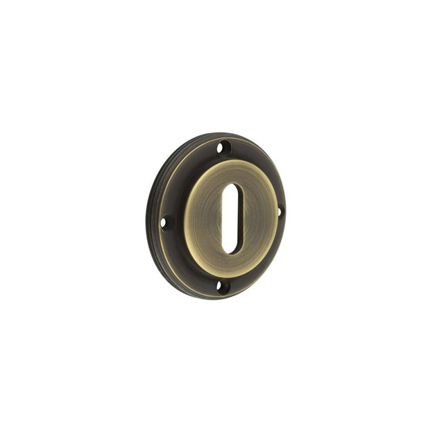 This is an image showing the Burlington - inner escutcheon std keyway - Antique Brass available to order from T.H. Wiggans Ironmongery in Kendal