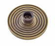 This is an image showing the Burlington - Reeded door stop base - Antique Brass available to order from T.H. Wiggans Ironmongery in Kendal