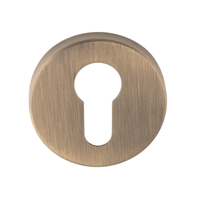 This is an image of Eurospec - Euro Escutcheon - Antique Brass - CSE1005AB available to order from T.H. Wiggans Ironmongery in Kendal.