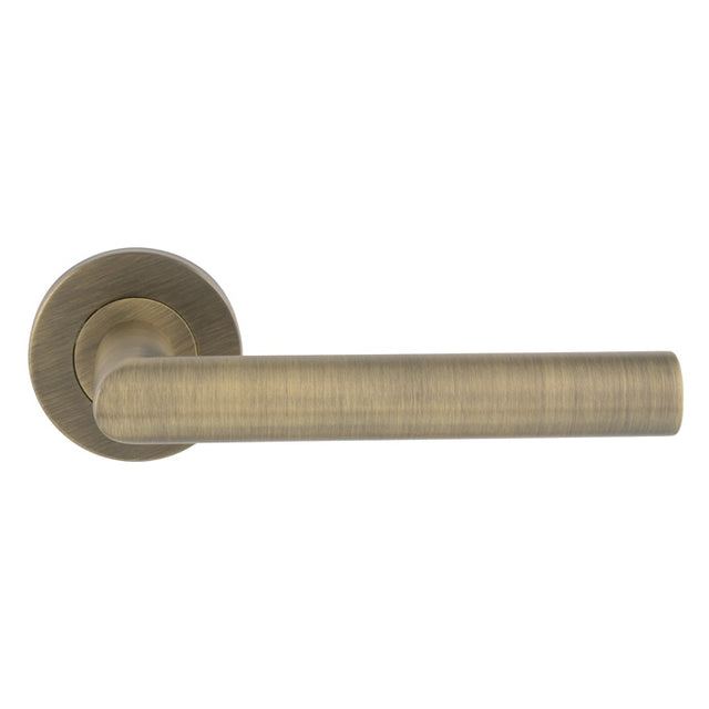 This is an image of Eurospec - Mitred Round Bar Lever on Sprung Rose - Antique Brass - CSL1192AB available to order from T.H. Wiggans Ironmongery in Kendal.