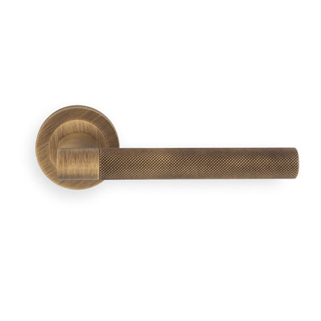 This image shows Manital - hey rete lever handle on threaded round rose bgo (antique brass) - antique brass - hn5ab available from T.H. Wiggans Ironmongery in Kendal.