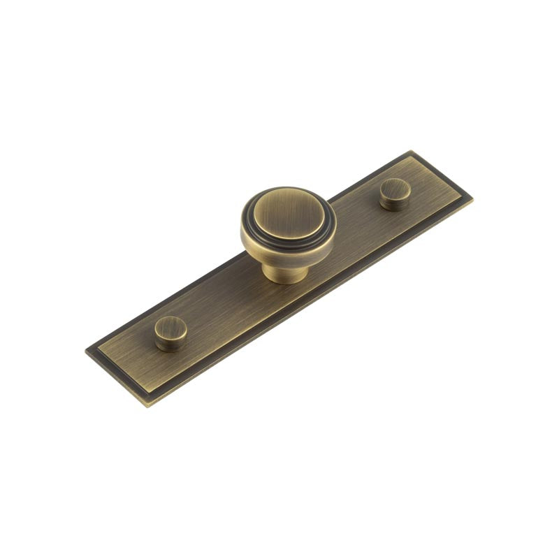 This is an image showing the Frelan - Cropley Cupboard Knobs 30mm Stepped Backplate Antique Brass available to order from T.H. Wiggans Ironmongery in Kendal