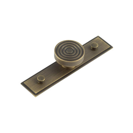 This is an image showing the Frelan - Murray Cupboard Knobs 40mm Stepped Backplate Antique Brass available to order from T.H. Wiggans Ironmongery in Kendal