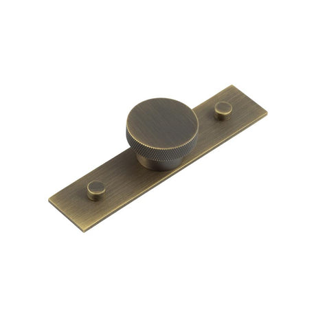 This is an image showing the Frelan - Wenlock Cupboard Knobs 40mm Plain Backplate Antique Brass available to order from T.H. Wiggans Ironmongery in Kendal