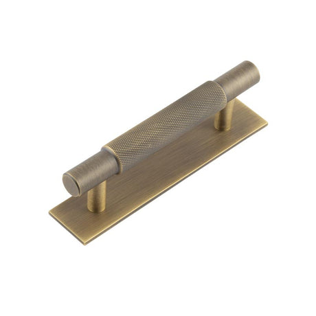 This is an image showing the Frelan - Hoxton Taplow Cabinet Handles 96mm Ctrs Plain Backplate Antique Brass available to order from T.H. Wiggans Ironmongery in Kendal