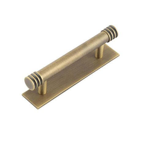 This is an image showing the Frelan - Hoxton Sturt Cabinet Handles 96mm Ctrs Plain Backplate Antique Brass available to order from T.H. Wiggans Ironmongery in Kendal