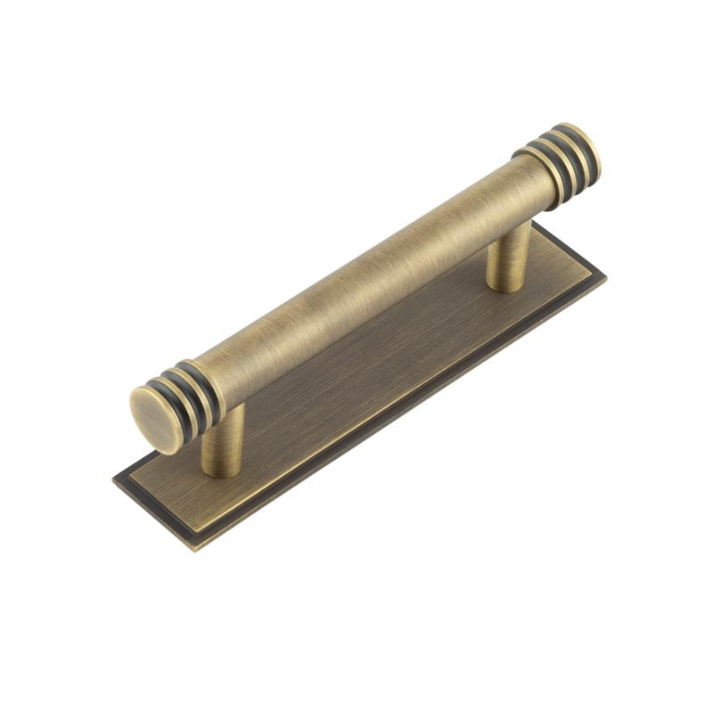 This is an image showing the Frelan - Hoxton Sturt Cabinet Handles 96mm Ctrs Stepped Backplate Antique Brass available to order from T.H. Wiggans Ironmongery in Kendal