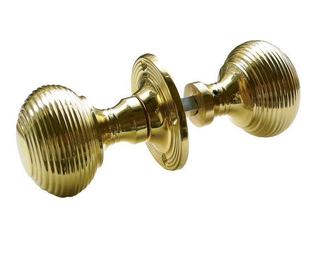 This is an image showing the Frelan - Reeded Unsprung Rim Knobs - Polished Brass available to order from T.H. Wiggans Ironmongery in Kendal