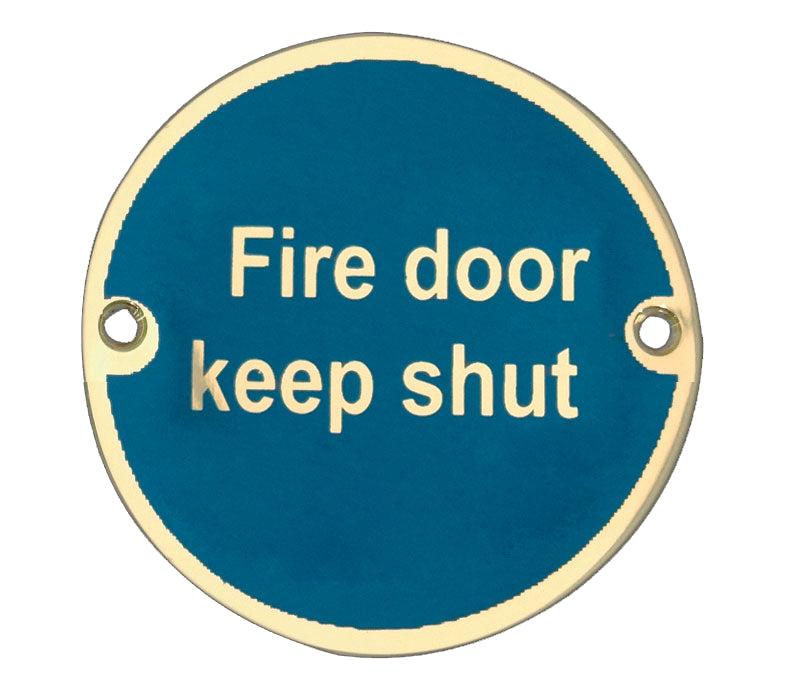 This is an image showing the Frelan - Fire Door Keep Shut' - Signage 75mm Dia. - Polished Brass available to order from T.H. Wiggans Ironmongery in Kendal