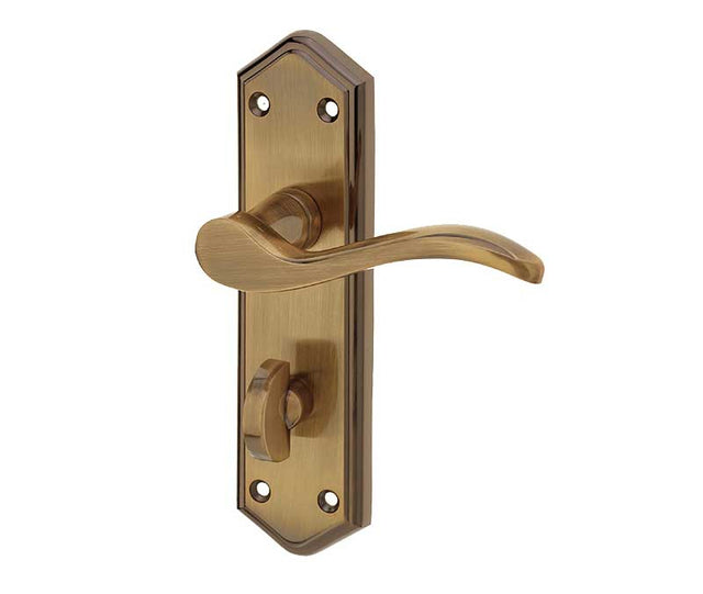 This is an image showing the Frelan - Paris Bathroom Lock Handles on Backplates - Antique Brass available to order from T.H. Wiggans Ironmongery in Kendal