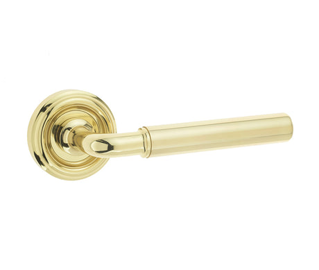 This is an image showing the Frelan - Elise Levers on Round Rose - Polished Brass available to order from T.H. Wiggans Ironmongery in Kendal