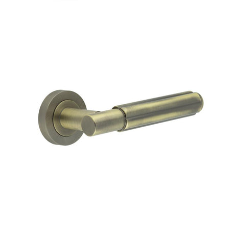 This is an image showing the Frelan - Bloom Antique Brass Lever on Rose available to order from T.H. Wiggans Ironmongery in Kendal