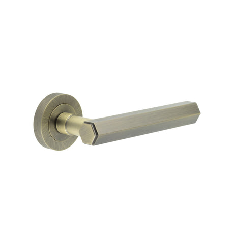 This is an image showing the Frelan - Jedo Hex Antique Brass Door Handle available to order from T.H. Wiggans Ironmongery in Kendal